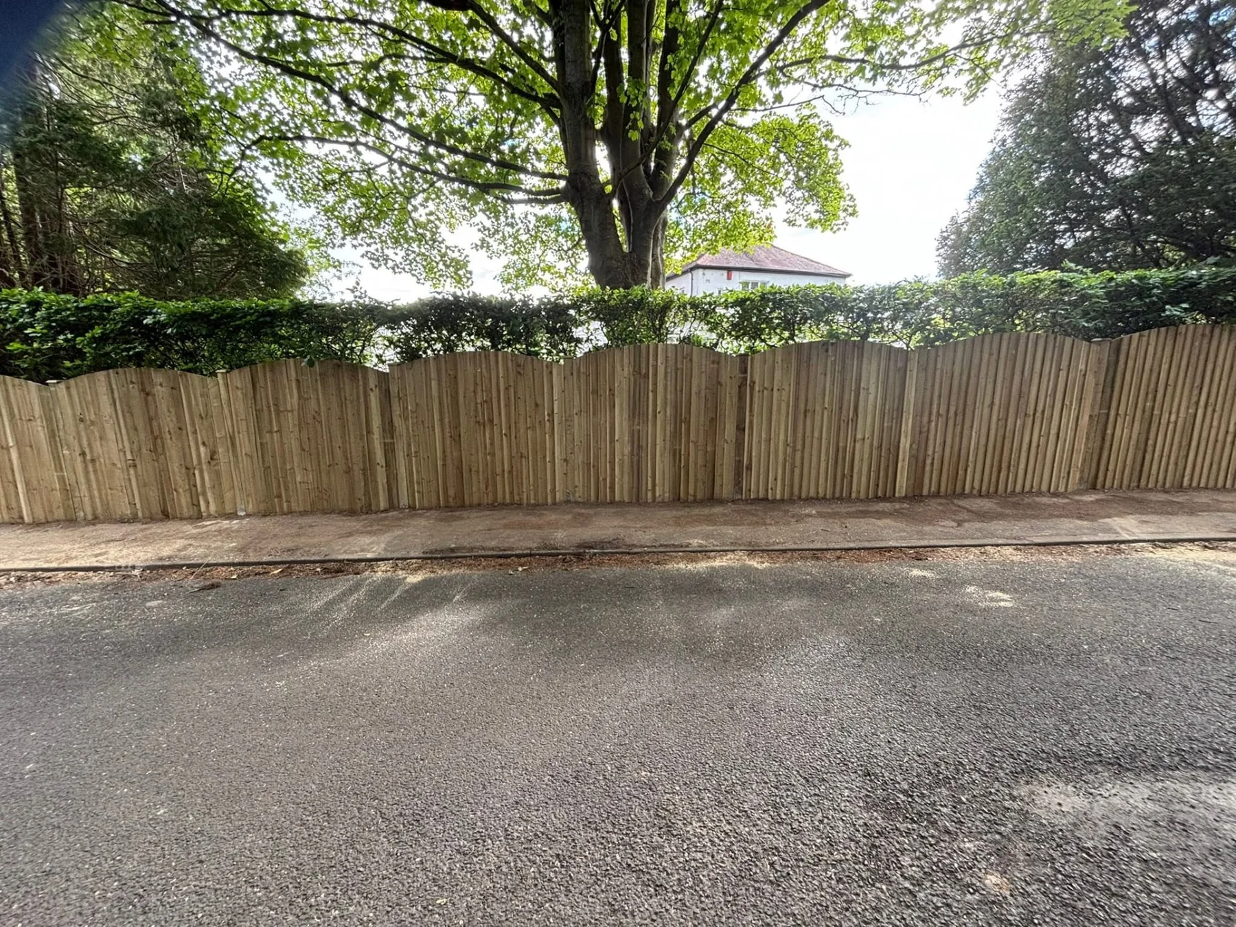 Long timber boundary fence installed by D.K Fencing & Paving
